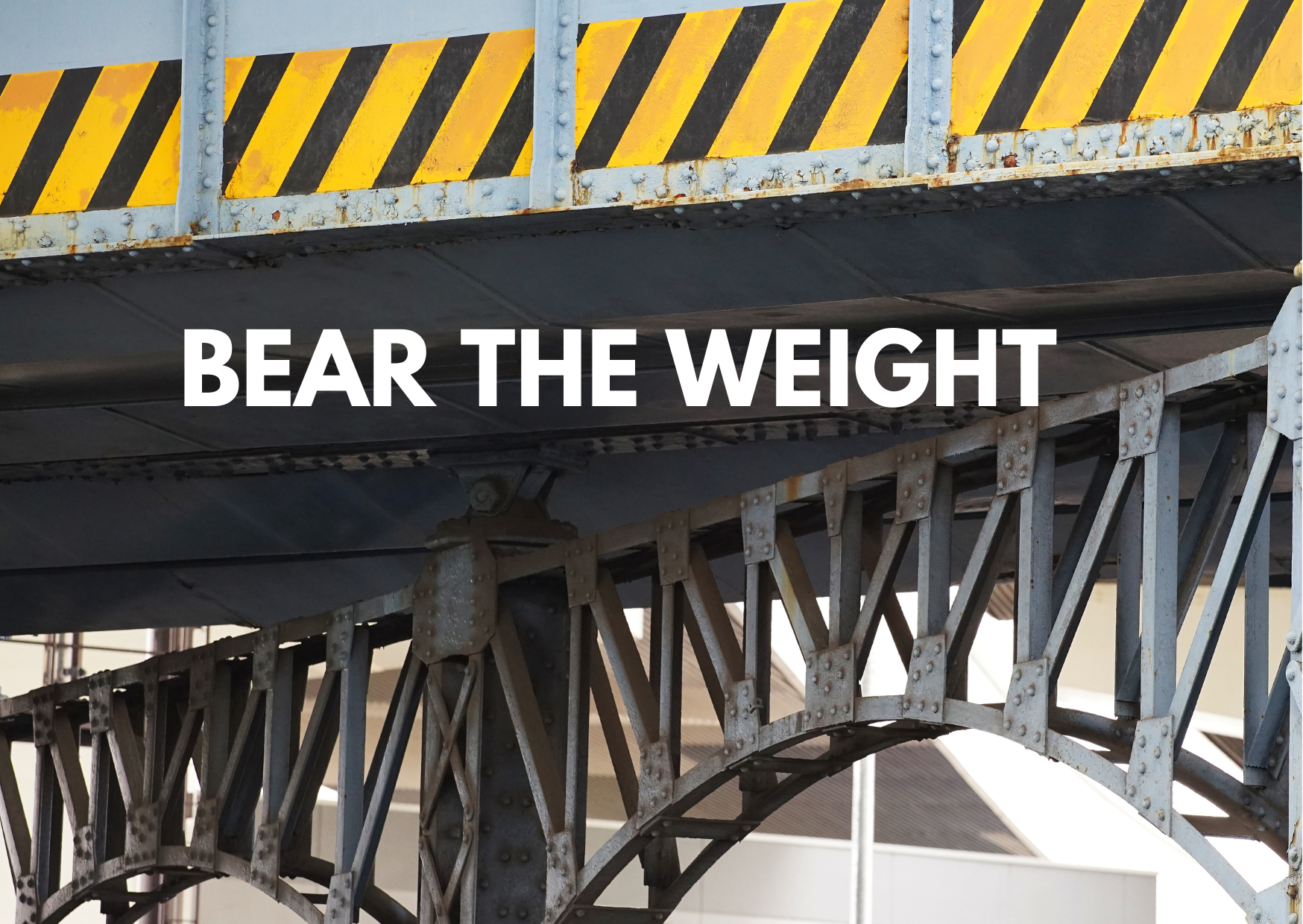 A picture showing support beams of a metal bridge with the caption "Bear The Weight"