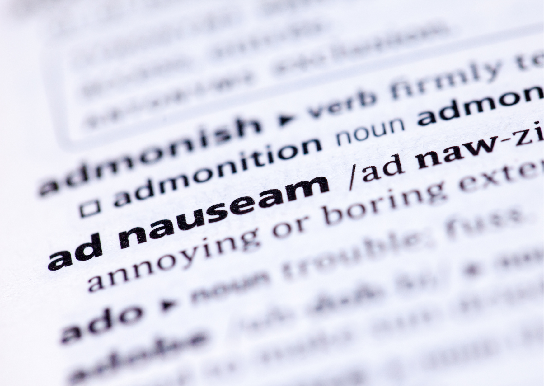 a picture of a dictionary page turned to show the meaning of "ad nauseam"